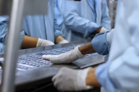 Tim produksi sedang melakukan pengecekan untuk meningkatkan kualitas produk di pabrik